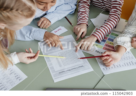 High angle view of boys and girls attending English language class doing task together, copy space 115042903