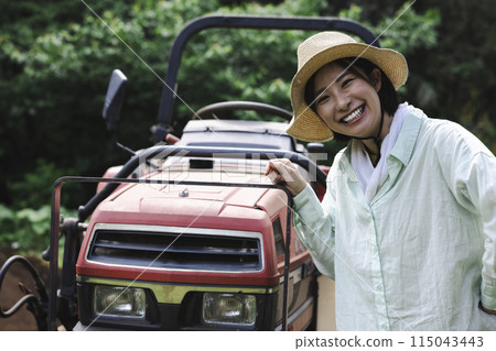 Woman plowing the field with a tractor Woman plowing the field with a tractor 115043443