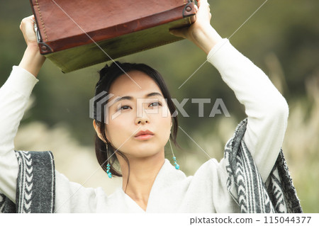 A woman traveling on a plateau A woman traveling on a plateau 115044377