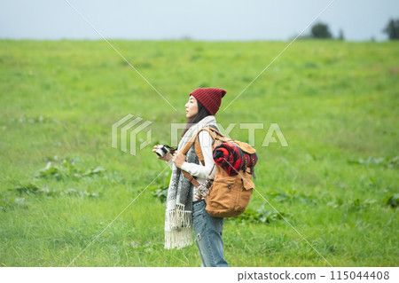 A woman holding a camera A woman holding a camera 115044408
