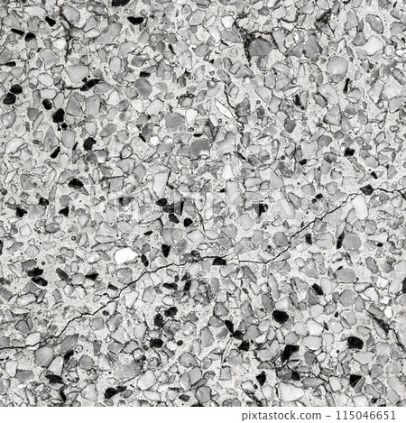 Black and white color stone mosaic floor. Old beautiful polished stone wall for background. 115046651