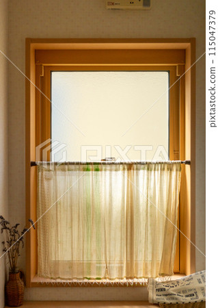 A toilet window with a frosted glass sash and cafe curtain A toilet window with a frosted glass sash and cafe curtain 115047379