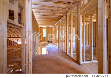 Framing of new unfinished residential home under construction using wood supports Framing of new unfinished residential home under construction using wood supports 115047741