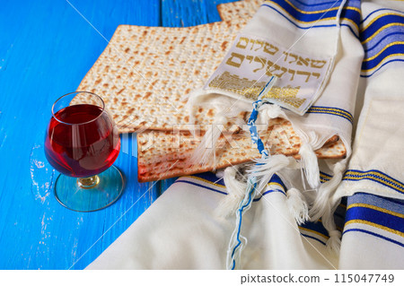 Red kosher wine unleavened bread matzo during seder meal with Pesach celebration holiday 115047749