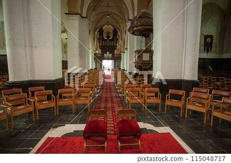 Interior of a historic church with wooden seats, red carpet, creating a sacred atmosphere Interior of a historic church with wooden seats, red carpet, creating a sacred atmosphere 115048717