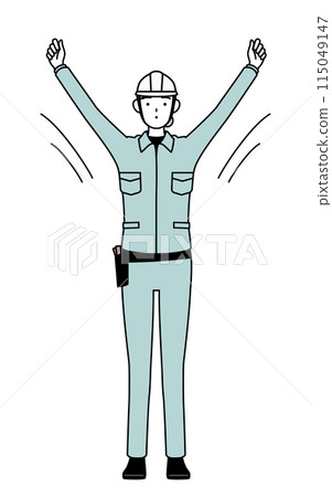 A female engineer in a helmet and work clothes doing radio exercises 115049147