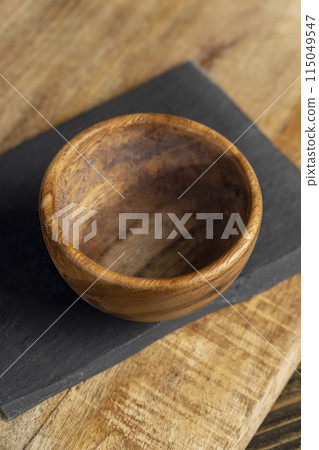 close-up of an empty old wooden bowl with a round shape close-up of an empty old wooden bowl with a round shape 115049547