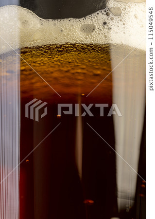 dark beer in a glass glass, fresh dark alcoholic beer dark beer in a glass glass, fresh dark alcoholic beer 115049548