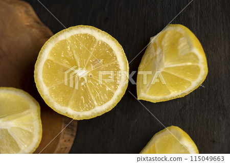 close-up of a table with slices of yellow lemon close-up of a table with slices of yellow lemon 115049663