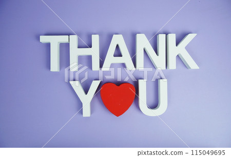 Thank You alphabet letters top view on purple background Thank You alphabet letters top view on purple background 115049695
