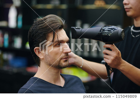 Barber blow drying 115049809
