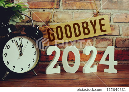 Goodbye 2024 letters with alarm clock on wooden background Goodbye 2024 letters with alarm clock on wooden background 115049881