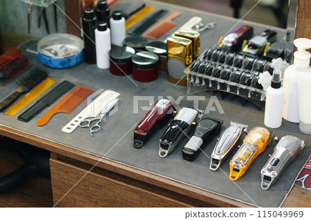 Set of clippers, combs and scissors on table on barber 115049969