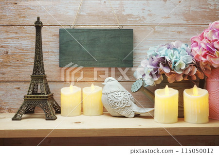 Empty wooden hanging on wooden background with home decoration on wooden shelve 115050012