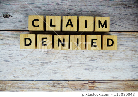 Claim Denied with wooden blocks alphabet letters on wooden background 115050048