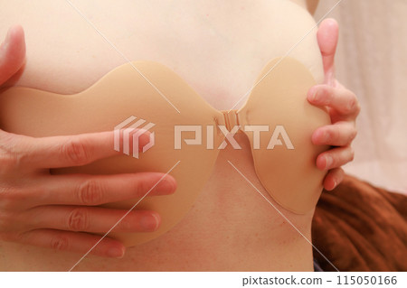 A woman wearing a silicone bra 115050166
