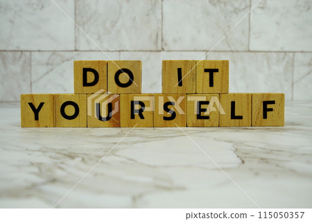 Do It Yourself with wooden blocks alphabet letters on marble background Do It Yourself with wooden blocks alphabet letters on marble background 115050357