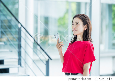 Business person who operates a smartphone Business person who operates a smartphone 115050517