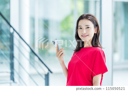 Business person who operates a smartphone Business person who operates a smartphone 115050521