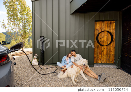 Lovely couple with their dog near a modern house 115050724