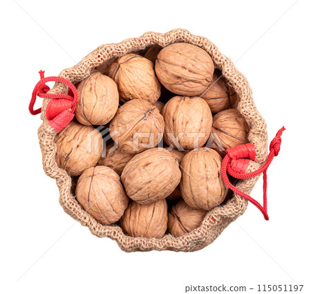 Walnuts in their shells, in an opened gunny sack. Unshelled dried seeds of common walnut tree Juglans regia. Whole nuts with shells, used as snack, for baking and as decoration, in an opened jute bag. 115051197