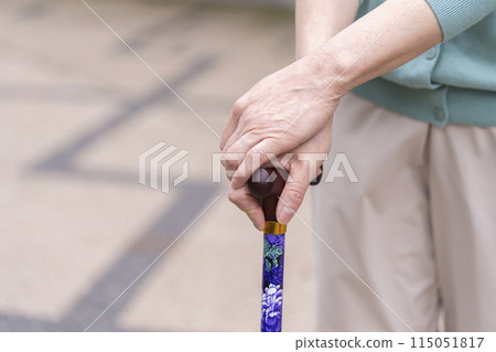Hands of a senior woman using a cane Hands of a senior woman using a cane 115051817
