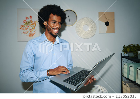 Businessman Checking Email on Laptop Businessman Checking Email on Laptop 115052035