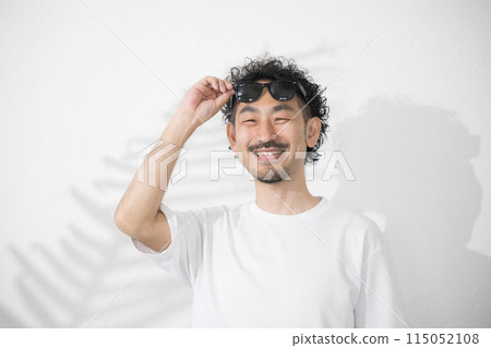 A man wearing sunglasses because the sun is too bright 115052108