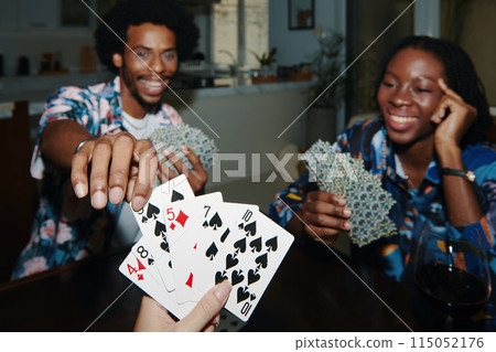 Friends Enjoying Playing Cards Friends Enjoying Playing Cards 115052176