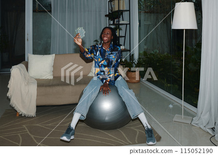 Happy Woman Sitting on Fitness Ball Happy Woman Sitting on Fitness Ball 115052190