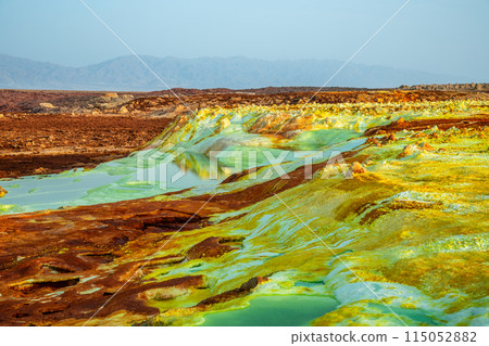 Unearthy landscape with toxic lakes and sulphur minerals, Danakil Depression desert, Afar region, Ethiopia 115052882