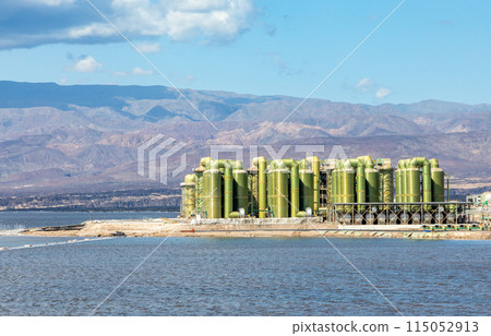 Lac Assal salt lake waters with salt extraction factory in the background, the lowest point of Africa, Tadjourah Region, Djibouti Lac Assal salt lake waters with salt extraction factory in the background, the lowest point of Africa, Tadjourah Region, Djibouti 115052913