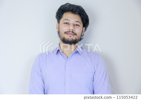 Man smiling in front of a white background 115053422