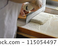 A man cutting buckwheat flour for a handmade soba noodle experience 115054497