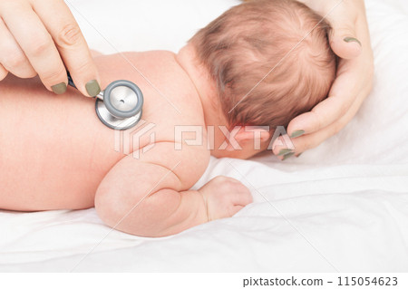 Doctor Examining Newborn with Stethoscope Doctor Examining Newborn with Stethoscope 115054623