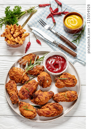 american style fried chicken wings on a plate american style fried chicken wings on a plate 115054926