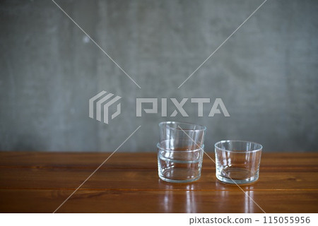 Glass cups piled up on the table Glass cups piled up on the table 115055956