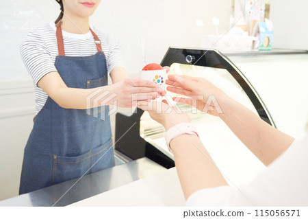 Sales staff handing out strawberry gelato Sales staff handing out strawberry gelato 115056571