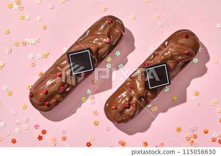 Chocolate-covered pecan bars with berry sprinkles on pink Chocolate-covered pecan bars with berry sprinkles on pink 115056630