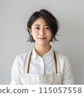 A young woman in an apron 115057558