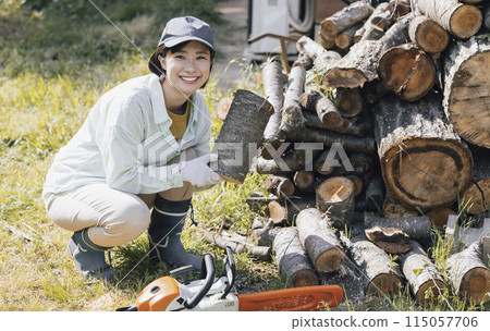 Woman cutting firewood Woman cutting firewood 115057706