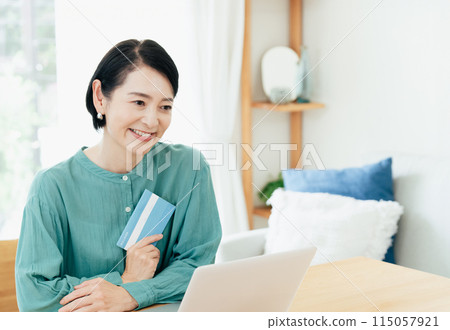 Middle-aged woman holding a bankbook 115057921
