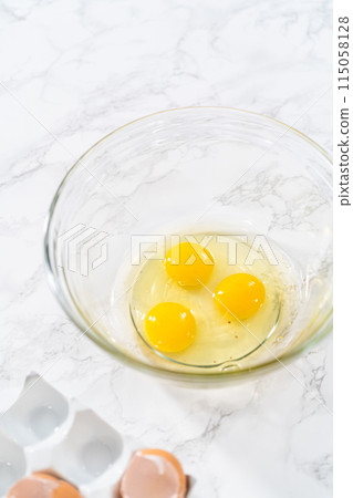 Measured ingredients in glass mixing bowls to bake American flag mini cupcakes. 115058128