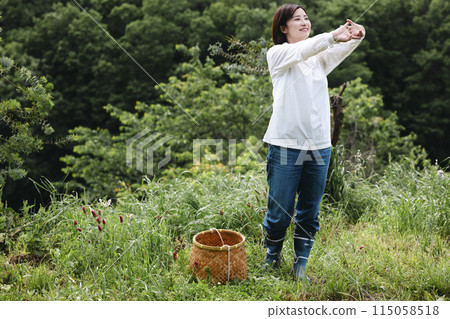 Cute woman enjoying country life Cute woman enjoying country life 115058518