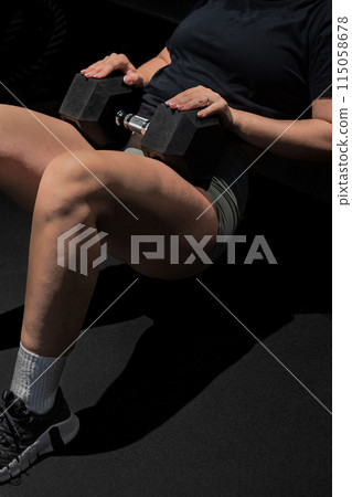 Woman in sportswear with dumbbells keywords hand, waist, finger, knee 115058678