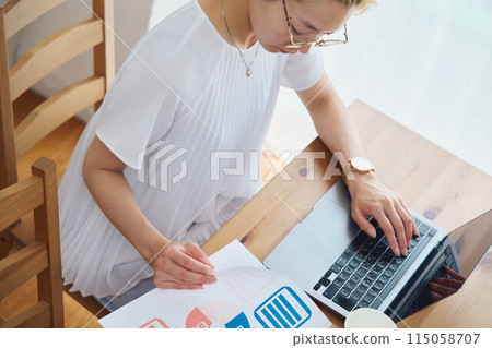 Woman doing work at home 115058707