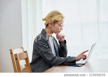 Woman doing work at home 115059235