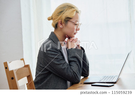 Woman doing work at home 115059239