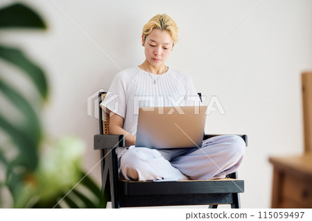 A woman working at home at home A woman working at home at home 115059497