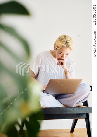 A woman working at home at home A woman working at home at home 115059501